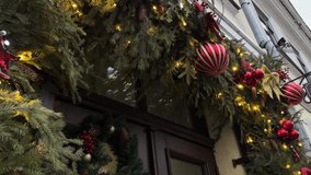 Festive street decoration adorned with evergreen garlands, vibrant ornaments, and twinkling lights, creating a warm holiday atmosphere for New Year celebrations - Powered by Shutterstock - Get 15% off with code: PIKWIZARD15
