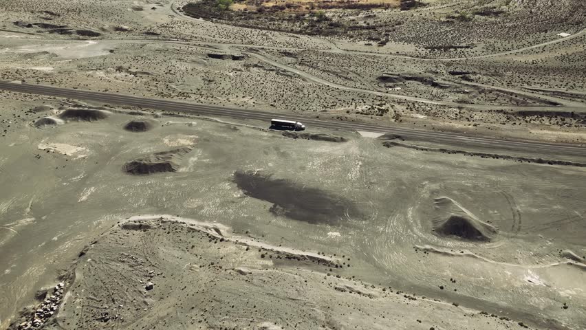 Aerial drone view of Owens Lake and desert mountains with highway, California USA