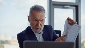 Angry ceo shouting at online meeting crumpling throwsing business documents in light office closeup. Mad senior boss arguing by video call. Furious executive finish virtual conference feeling stress. - Powered by Shutterstock - Get 15% off with code: PIKWIZARD15