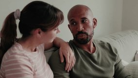 Happy couple relaxing together at home on the couch. Love, relationship, family, interracial, support, empathy - Powered by Shutterstock - Get 15% off with code: PIKWIZARD15