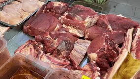 The seller demonstrates behind the counter what fresh meat the store has in stock. High quality 4k footage - Powered by Shutterstock - Get 15% off with code: PIKWIZARD15