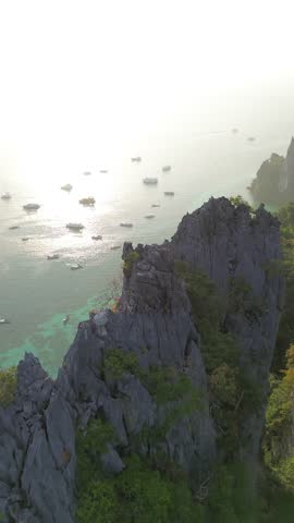 Beautiful coastline of the island. Limestone cliffs coastline of Phi Phi Don island in Krabi province, golden hour in the morning on the coast. View from a great height.