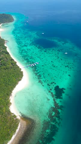 Vacation and tourism in Thailand. Beautiful islands of Koh Rok in the south of Thailand with turquoise water on the coast and green islands, view from a great height.