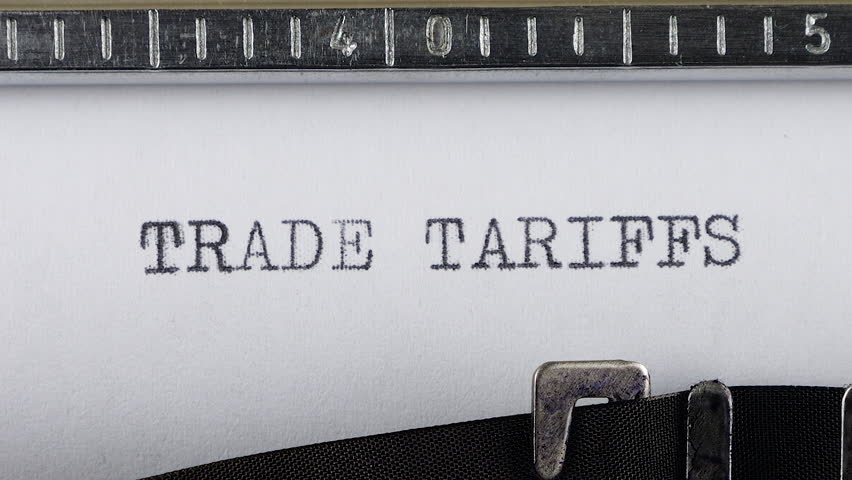 The phrase TRADE TARIFFS is typing on a retro typewriter.