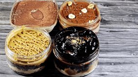 Assorted desserts of Tiramisu ladyfinger pastries (Savoiardi) dipped in coffee, Dark chocolate spread profiterole cream puffs, filled French choux pastry, biscuit and chocolate creamy with cake  - Powered by Shutterstock - Get 15% off with code: PIKWIZARD15