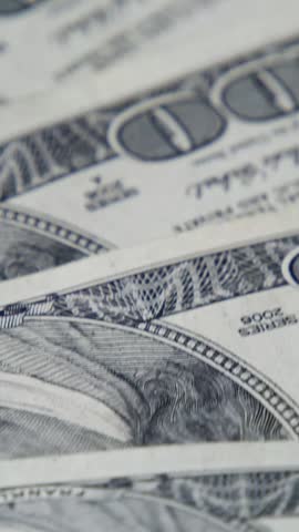 Vertical video. High-Definition Footage Of Money Scattering And Spinning Captures The Dynamic Flow Of Finance, Investment Growth, And Business Success With Realistic Detail.