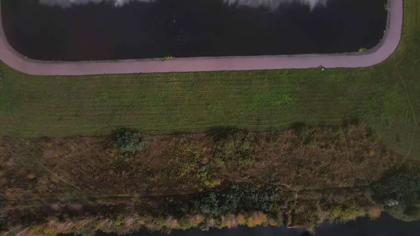 Aerial view of inactive spray ponds at Minsk TPP 5, showing rectangular basins, pathways, and surrounding green vegetation in a structured layout.
