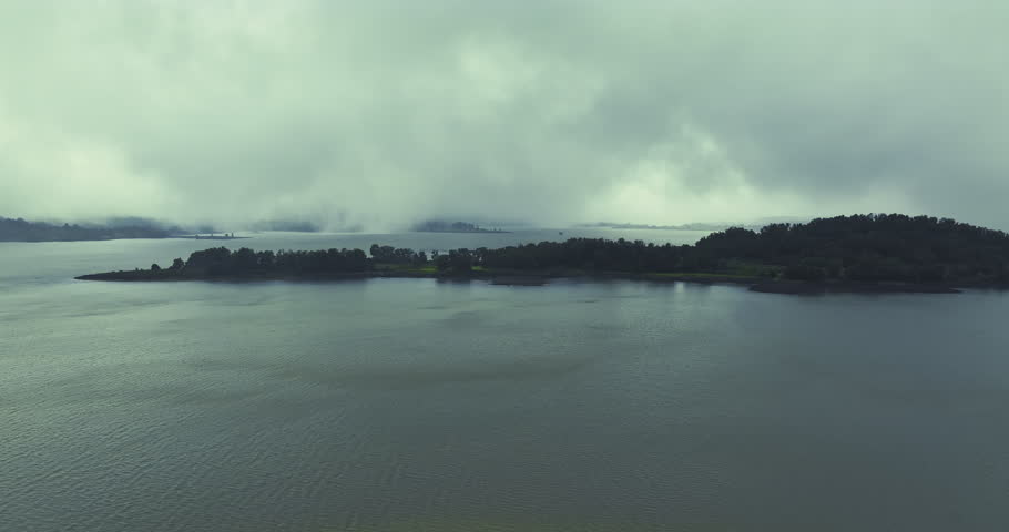 A beautiful Lake in Bhandardara, Maharashtra, during the peak monsoon season. The lush green landscape and powerful cascade reflect the natural grandeur of the Western Ghats.