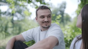 Young couple enjoying a peaceful day outdoors, bonding, talking, laughing, and playing guitar together in a natural, green park environment. - Powered by Shutterstock - Get 15% off with code: PIKWIZARD15