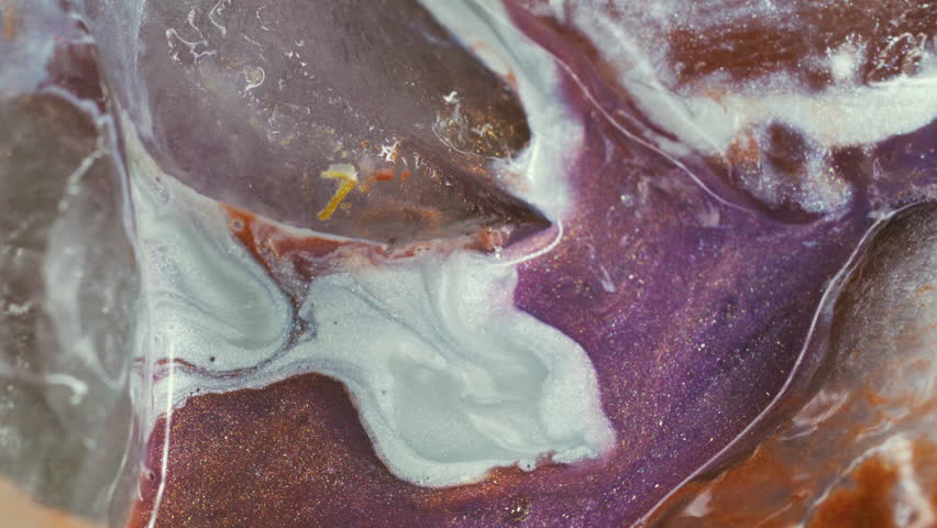 Ink flow. Frost background. Blur pink purple orange color sparkling white ice water floating on bright creative acrylic abstraction.