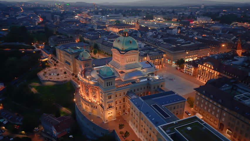 Stunning Aerial View of the Iconic Parliament building Illuminated by Evening Lights and Colors. Bern. Switzerland