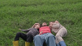 Happy family lying on grass, enjoying nature - Powered by Shutterstock - Get 15% off with code: PIKWIZARD15
