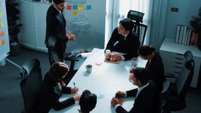 Top view of smart business team brainstorm idea by writing in sticky notes at meeting. Group of professional analysts planning marketing strategy and brainstorming in conference. Teamwork. Directorate - Powered by Shutterstock - Get 15% off with code: PIKWIZARD15