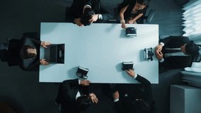 Top down aerial view of professional business team wear vr headset to enter virtual world while sitting and using hand gestures to manipulate the data from the manager laptop. Time lapse. Directorate. - Powered by Shutterstock - Get 15% off with code: PIKWIZARD15