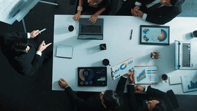 Top down aerial view of professional businessman talking and planning marketing strategy while standing at white board. Group of diverse team brainstorm idea at table with financial graph. Directorate - Powered by Shutterstock - Get 15% off with code: PIKWIZARD15