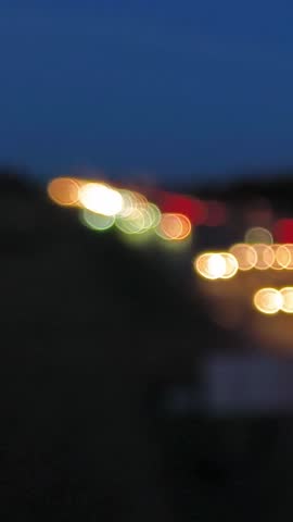 Blurred car lights on a highway at night, creating an out-of-focus bokeh effect.