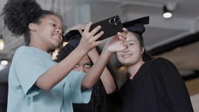 group of teenage girls take selfies with their smartphones to congratulate their friends on their graduation day - Powered by Shutterstock - Get 15% off with code: PIKWIZARD15