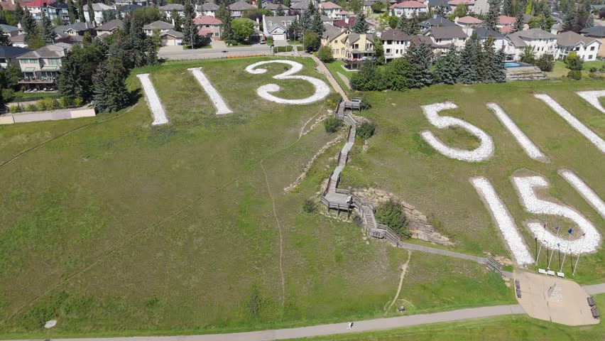 Aerial view of Battalion Park, in Signal Hill, built to commemorate WWI. It features historical stone formations, a pathway, and a lookout landing.