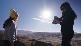 Mother sharing traditional South American yerba mate drink with daughter, cultural heritage - Powered by Shutterstock - Get 15% off with code: PIKWIZARD15