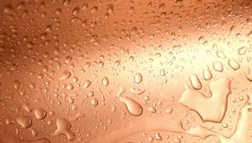 A dynamic close-up of amber-colored liquid or condensation flowing down a smooth surface. This abstract motion is perfect for themes related to beverages, whiskey, beer, or a refreshing and delicious - Powered by Shutterstock - Get 15% off with code: PIKWIZARD15