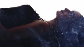 Vertical video. Galaxy silhouette. Female universe. Double exposure glitter stardust smoke cloud in dark profile of cosmic dreamy inspired woman face isolated on white. - Powered by Shutterstock - Get 15% off with code: PIKWIZARD15
