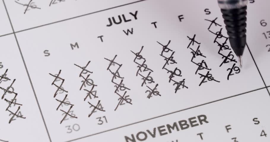 July calendar page with the days crossed out in black pen. Time, deadlines, and important dates concept. Crossing Out Days On Calendar