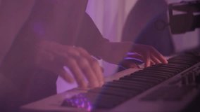 Close-up of a man's hands playing synthesizer keys in a nightclub in flashing neon light. Musicians play live music in a disco club. - Powered by Shutterstock - Get 15% off with code: PIKWIZARD15