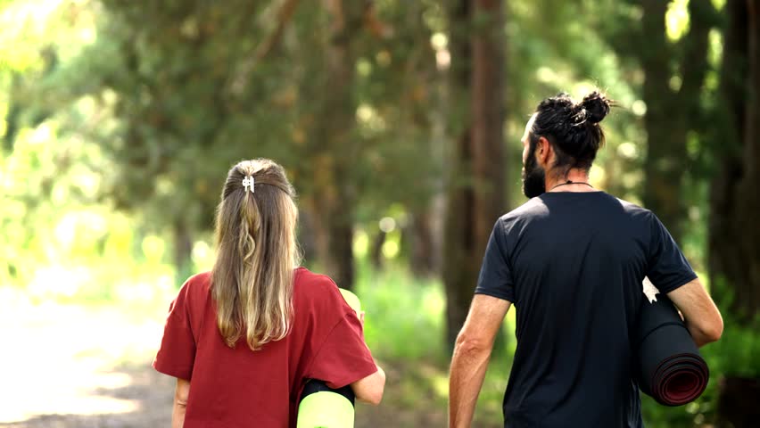Couple Walking In Forest With Yoga Mats, Ready For Outdoor Workout, Healthy Lifestyle In Nature, Fitness Motivation, Wellness Journey. Mindful Exercise, Forest Bathing Outdoor Recreation Yoga Practice