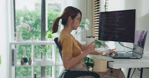 Young Asia female freelance eyeglasses drink coffee and type write prompt AI bot IT app program nomad, video game, terminal with coding, user interface, data center on desktop computer at home office. - Powered by Shutterstock - Get 15% off with code: PIKWIZARD15
