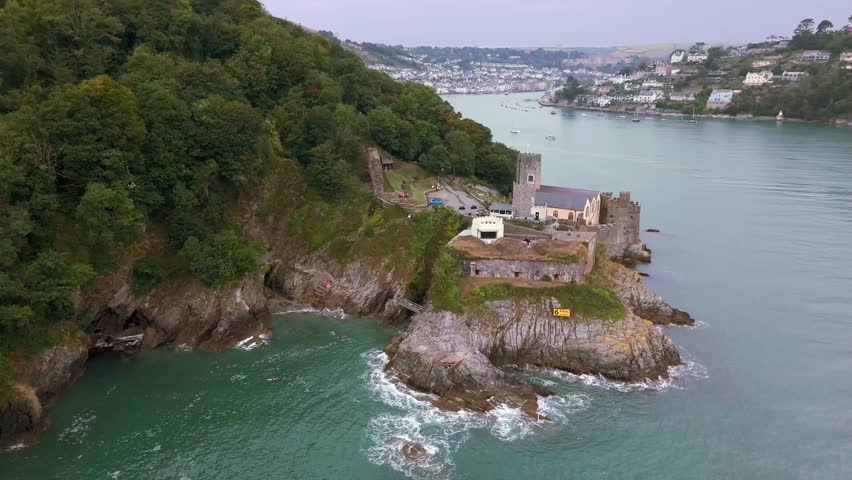 Daytime, aerial reverse over Dartmouth Castle out to sea with Estuary in background.