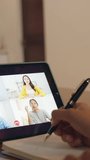 Vertical Screen : Asia businesswoman using digital tablet talk to colleague about plan by video call brainstorm online meeting while remotely work from home at kitchen. Social distancing, quarantine. - Powered by Shutterstock - Get 15% off with code: PIKWIZARD15