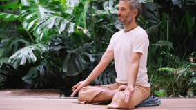 Man practicing leg lift on yoga mat with relaxed focus - Powered by Shutterstock - Get 15% off with code: PIKWIZARD15