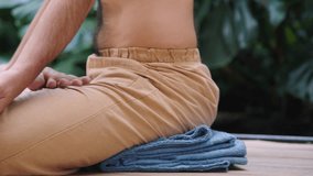 Man practicing arm balance on yoga mat with grounded focus - Powered by Shutterstock - Get 15% off with code: PIKWIZARD15