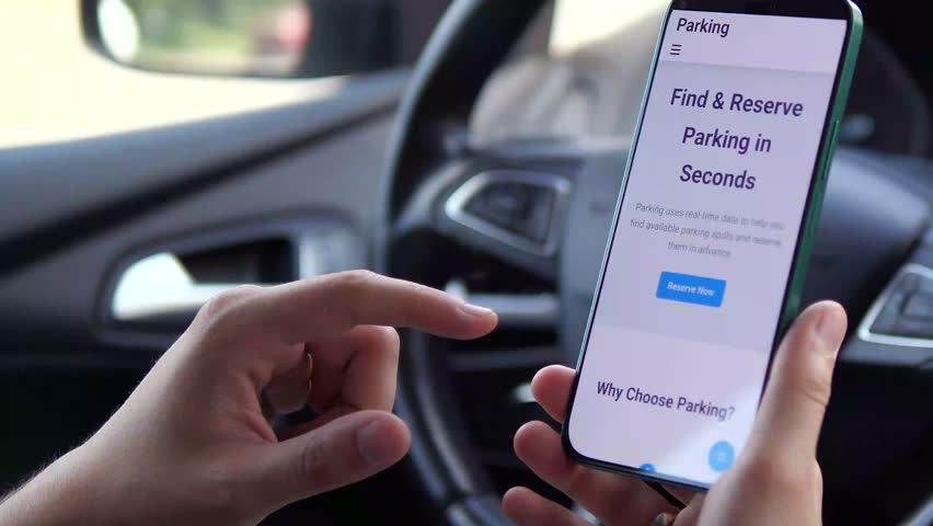 A driver's hands use a dedicated mobile app to effortlessly reserve and pre-pay for a parking spot. This clip highlights urban convenience, smart city technology, and stress-free travel planning