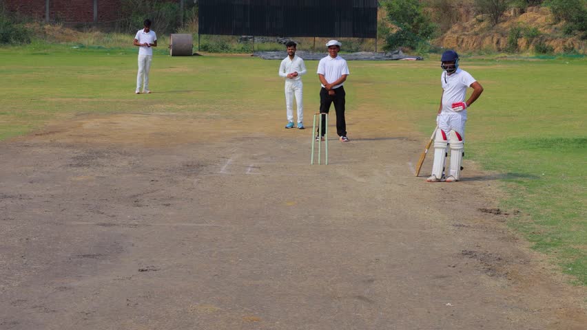 Young men playing cricket on the field, During Youth Cricket Match