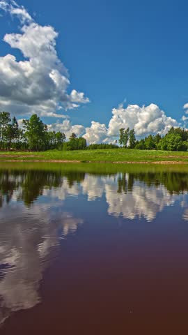 Vertical View Of Serene Lake With Clouds Reflection. Timelapse