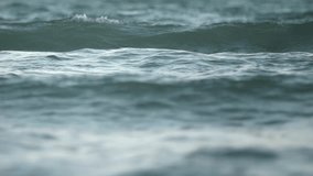 Slow motion recording of ocean swell at sunset with compressed wave layers from a telephoto perspective. - Powered by Shutterstock - Get 15% off with code: PIKWIZARD15