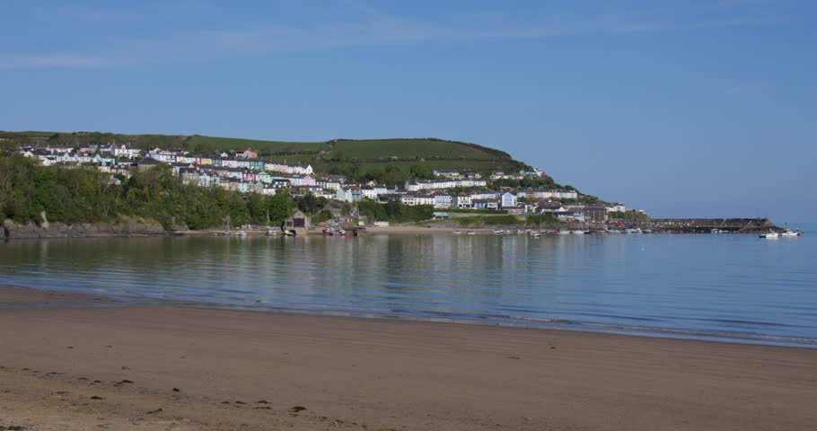 Wide shot of new quay beach with town of new quay in background
