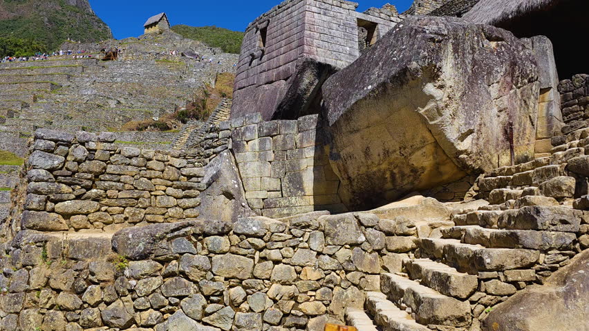 Incredible stonework of the Temple of the Sun at Machu Picchu, a masterpiece of Inca architecture. This footage highlights the religious importance and masterful construction of the sacred site.