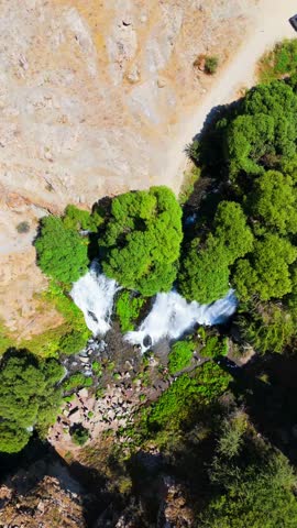 Scenic overhead shot of powerful waterfall streams, fresh greenery. Shaki Waterfall