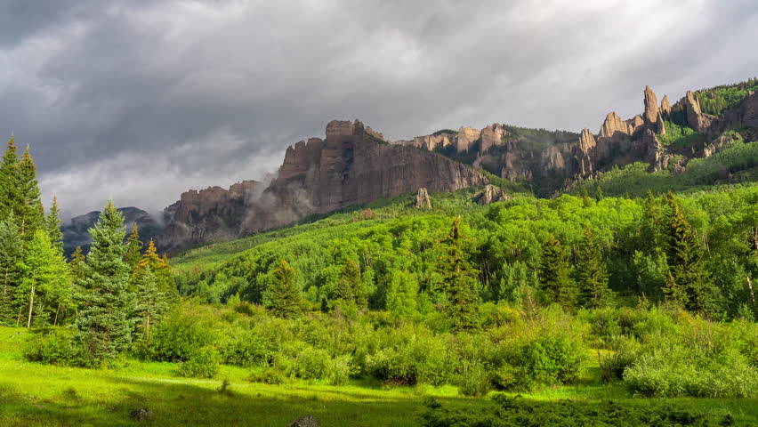 Time Lapse, Clouds and Shadows Moving Above Scenic Mountain Landscape and Rocky Cliffs