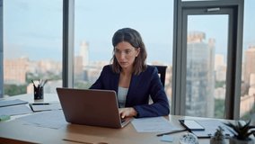 Serious woman employee planning business project at modern company workplace. Focused businesswoman looking laptop sitting corporate office. Confident lady thinking on marketing strategy at workspace. - Powered by Shutterstock - Get 15% off with code: PIKWIZARD15