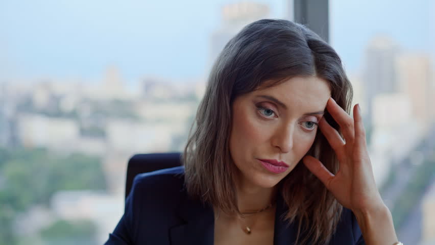 Concerned manager pondering solutions to business problems at corporate workplace closeup. Portrait stressed businesswoman thinking troubles in office. Serious woman worried company financial result.