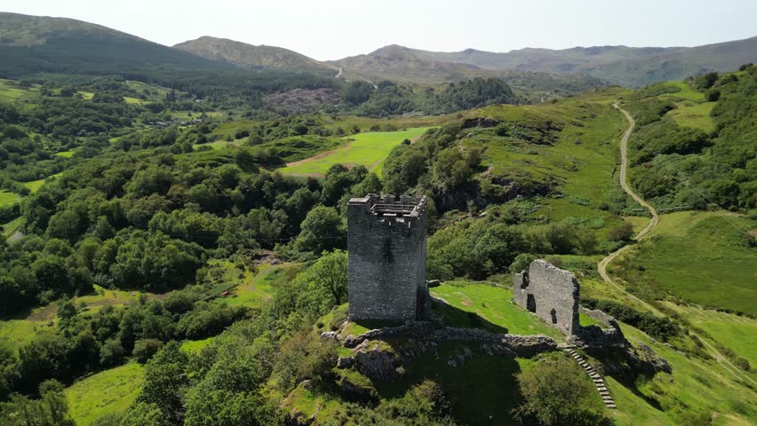 Dramatic Dolwyddelan Castle on a lovely summer afternoon - aerial drone slow clockwise rotate from far - North Wales, UK