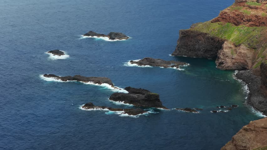 Aerial view of waves crashing against rocks in Calhau da Furna do Bode, Madeira Island, Portugal, creating white foam