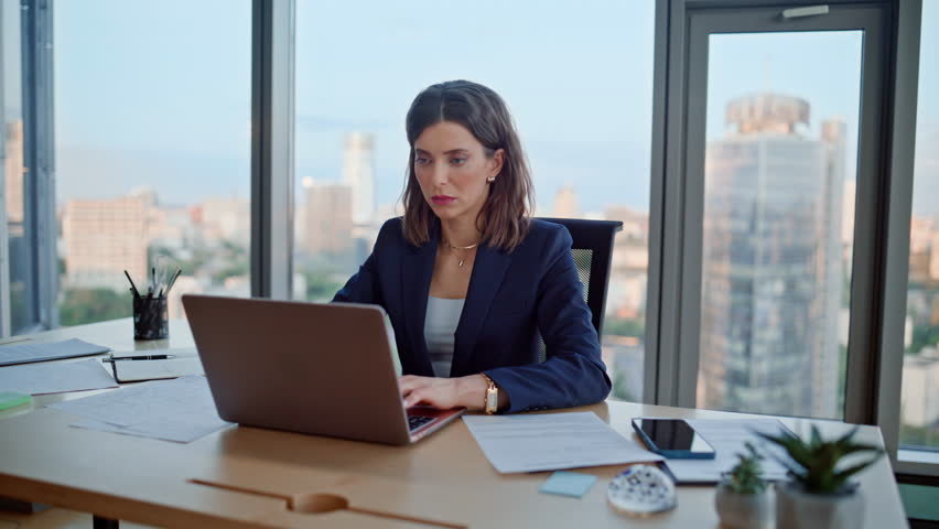 Office worker browsing laptop sitting modern workspace closeup. Unmotivated woman manager closing computer lid overwhelmed business tasks. Tired elegant businesswoman thinking on project at workplace.