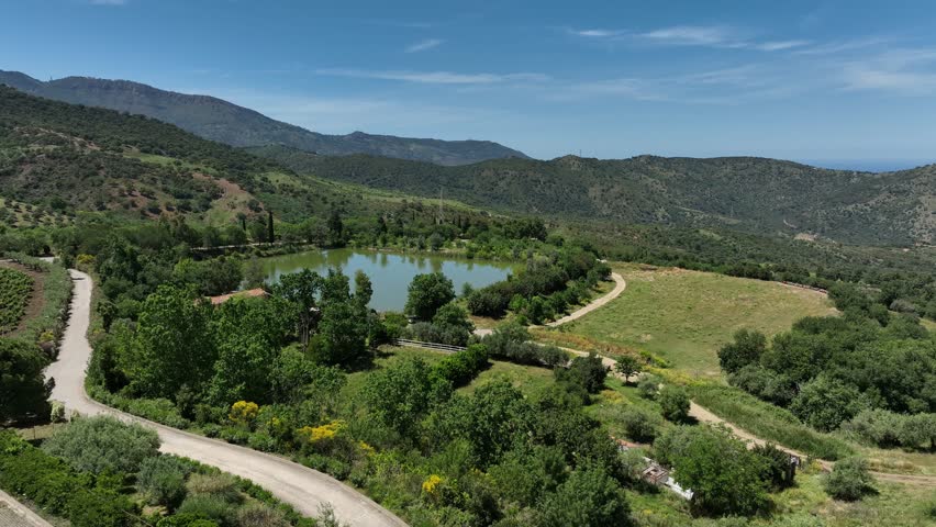 Aerial view of pond surrounded by hills