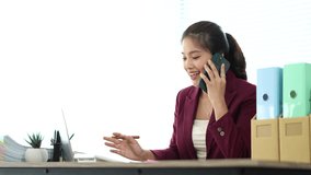 Asian businesswoman chatting on smartphone, auditor, document search, report, analysis, tax, accounting, document, data, contract, agreement at work. - Powered by Shutterstock - Get 15% off with code: PIKWIZARD15