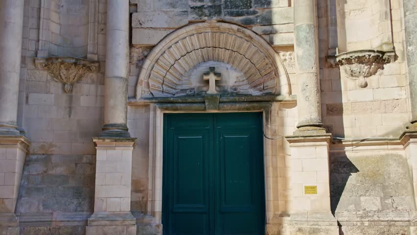Saint-Sauveur Church, stone facade, rose window, La Rochelle, France. Low-angle pov
