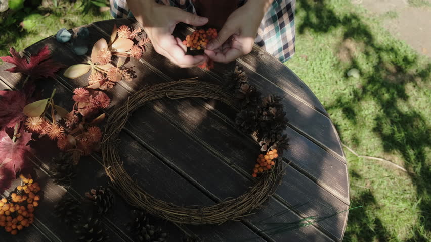 DIY fall wreath. Female hands creating autumn wreath